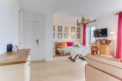 a living room with a couch and a table at LE PAIROLIERE AP4461 by Riviera Holiday Homes in Nice