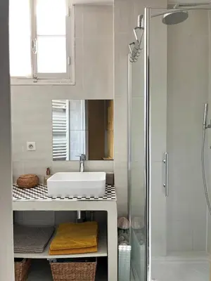 a white bathroom with a sink and a shower at Berlioz Blue AP4458 by Riviera Holiday Homes in Nice