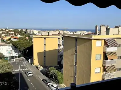 a view of a street and a yellow building at Appartement de Tim in Cagnes-sur-Mer