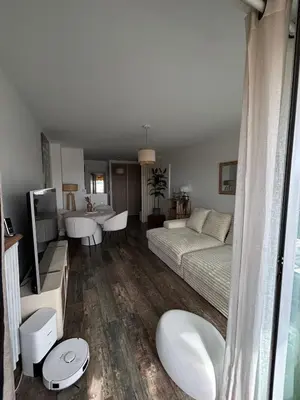 a bedroom with a bed and a living room at Appartement de Tim in Cagnes-sur-Mer