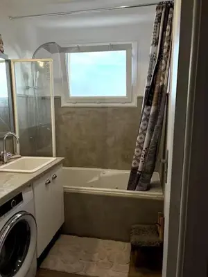 a bathroom with a tub and a sink and a toilet at Appartement de Tim in Cagnes-sur-Mer