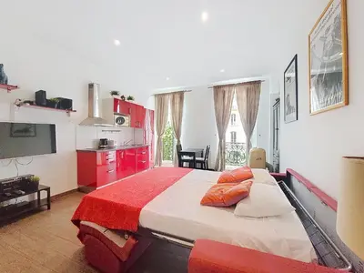 a bedroom with a large bed with red cabinets at Nestor&Jeeves - DOLCE VITA STUDIO - Balcon - Central in Nice