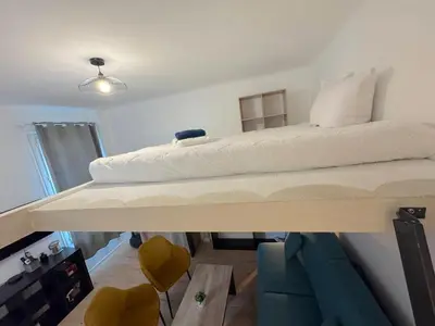 a small kitchen with a white refrigerator and a table at ⁂Appartement élégant plage à 100m prom des anglais in Nice