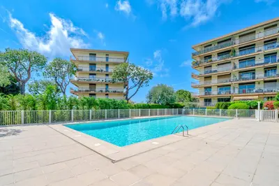 a swimming pool in front of a building at Studio Vue mer Parking Clim in Nice