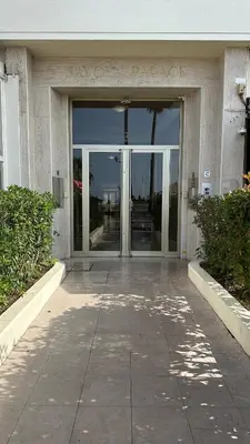 a building with the entrance to a new york palace at Carre d Or Face a la Mer in Nice