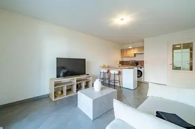 a living room with a couch and a tv at Cozy 2P Port de Nice garage in Nice