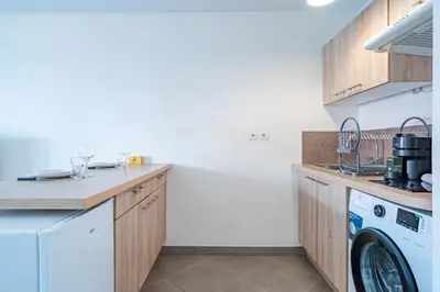 a kitchen with a washing machine and a washer at Cozy 2P Port de Nice garage in Nice