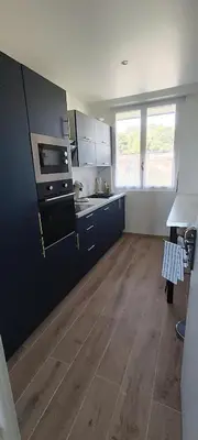 a kitchen with a counter and a stove top oven at Appartement vue mer et panoramique, 2 chambres, 3 lits in Nice