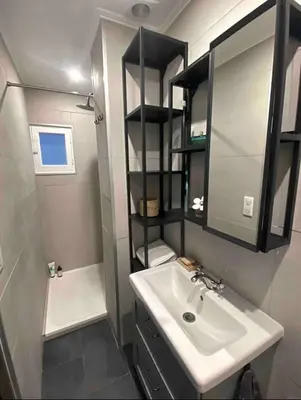 a small bathroom with a sink and a mirror at Nice centre studio rénové avec emplacement central in Nice