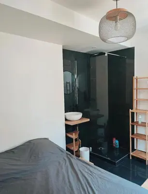 a bedroom with a bed and a bathroom with a sink at Nice vieille ville appartement design, proche de tout in Nice