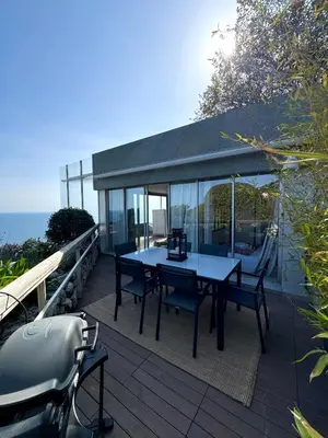 a patio with a table and chairs on a deck at Casa Monaco - Costa plana résidence in Cap d'Ail