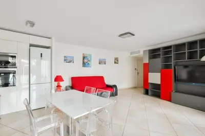a living room with a white table and a red couch at Charming stay in Nice in Nice