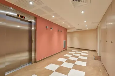 an empty hallway with a door and a checkered floor at Charming stay in Nice in Nice
