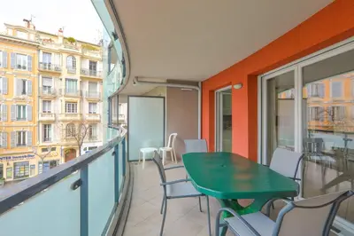 a balcony with a green table and chairs at Charming stay in Nice in Nice