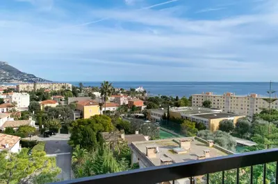 a view of a city from a balcony at 3 rooms panoramic sea view in Beaulieu-sur-Mer