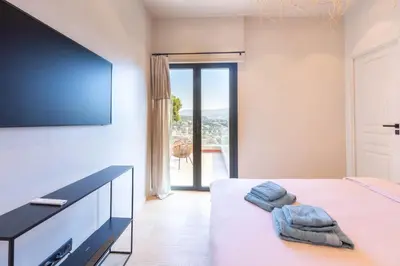 a bedroom with a bed with a flat screen tv at Sublime villa d'architecte, piscine et parking in Nice