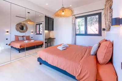 a bedroom with a bed and a mirror at Sublime villa d'architecte, piscine et parking in Nice