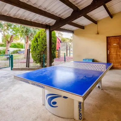 a ping pong table sitting in the middle of a patio at Résidence Héliotel Marine in Saint-Laurent-du-Var