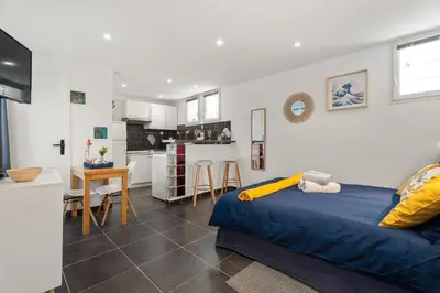 a bedroom with a blue bed and a kitchen at Nice Renting - 5b PENCHIENATTI - Charming Cozy Studio Balcony AC Massena in Nice