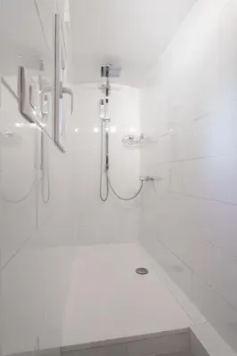 a white bathroom with a shower and a sink at Nice Renting - 5b PENCHIENATTI - Charming Cozy Studio Balcony AC Massena in Nice