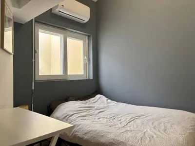 a small bedroom with a bed and a window at Nice Signature Delille in Nice