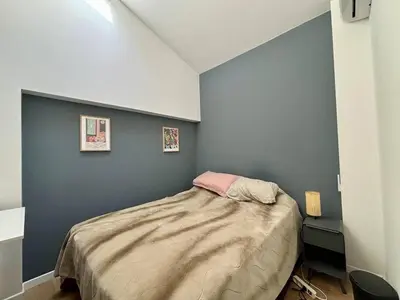 a bedroom with a bed with a blue wall at Nice Signature Delille in Nice