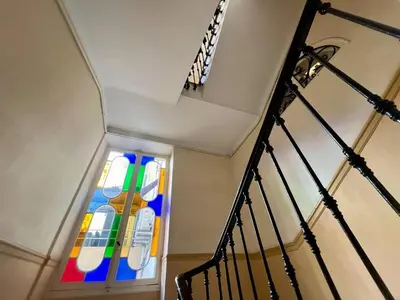 a stained glass window in a stair case at Nice Signature Assalit Studio in Nice