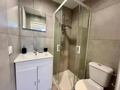a bathroom with a shower and a toilet and a sink at Nice Signature Assalit 2P in Nice