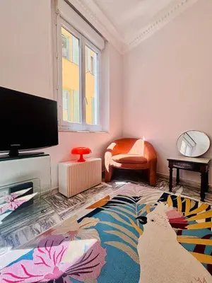 a living room with a flat screen tv and a rug at Centre ville-vieille ville-promenade des Anglais in Nice