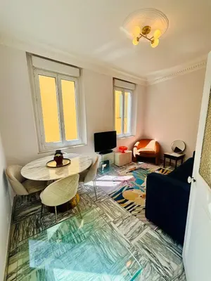 a living room with a table and a couch at Centre ville-vieille ville-promenade des Anglais in Nice