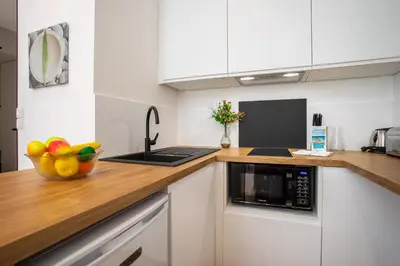 a kitchen with a microwave and a bowl of fruit on a counter at ICONIC AP4460 By Riviera Holiday Homes in Nice