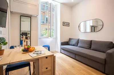 a living room with a couch and a table at ICONIC AP4460 By Riviera Holiday Homes in Nice