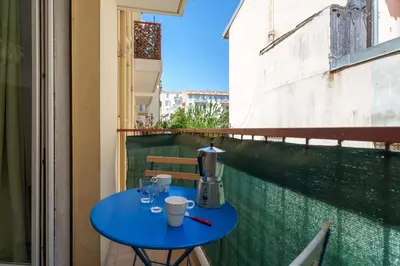 a blue table with a coffee maker on a balcony at Studio Malaussena - Welkeys in Nice