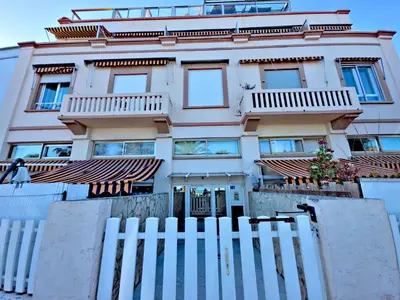 a building with a white fence in front of it at Panoramic Sea View Studio in Cagnes-sur-Mer