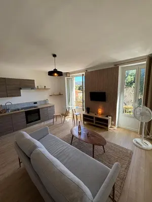a living room with a couch and a table at 2P Central Nice in Nice