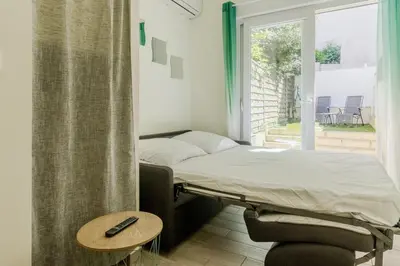 a hospital room with a bed and a table at Nice Magnan studio avec jardin proche des plages in Nice
