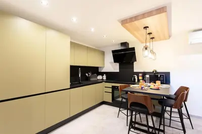 a kitchen with a table and chairs in a room at #45 Quiet chic 5mins walk to port and beach AC Wifi in Villefranche-sur-Mer