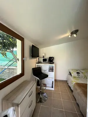 a bedroom with a bed and a desk and a chair at Cabana 12 m2 in Nice