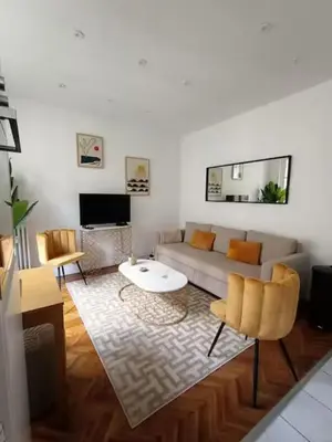a living room with a couch and a table at Superbe appartement, aperçu mer, Negresco-centre in Nice
