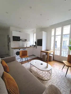 a living room with a couch and a table at Superbe appartement, aperçu mer, Negresco-centre in Nice