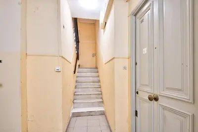 a hallway with a staircase leading up to a door at Appartement Cosy centre Nice in Nice