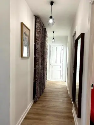 a living room with a table and a tv at Charming Flat in Nice Villa in Nice