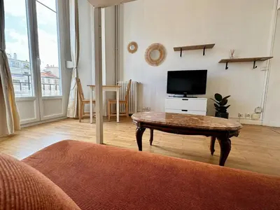 a living room with a coffee table and a tv at Liberation Cozy Studio in Nice in Nice