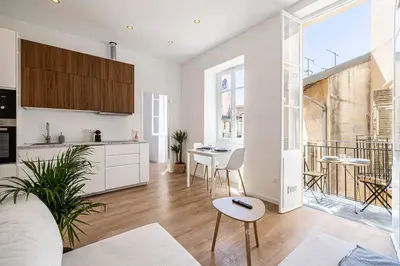 a kitchen and living room with a table and chairs at Appartement neuf 2 pièces Port in Nice