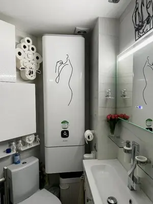 a white bathroom with a toilet and a sink at Petit Bijou niçois in Nice