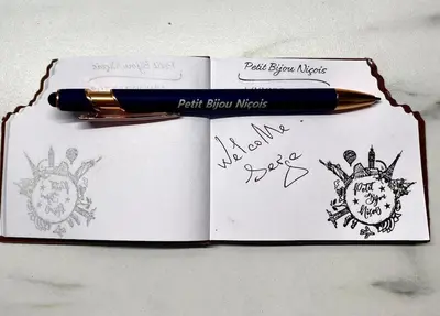 a pen sitting on top of a notebook at Petit Bijou niçois in Nice
