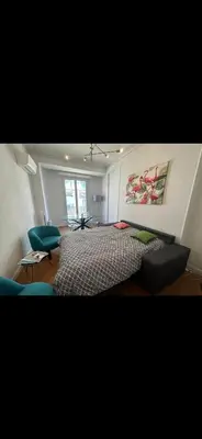 a bedroom with a bed and two chairs in it at Two bedroom Apartment to rent in Nice in Nice