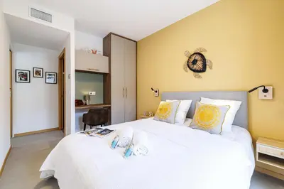 a bedroom with a large white bed and yellow walls at MY CASA - GAIRAUT - 5 rooms - Terrasse in Nice