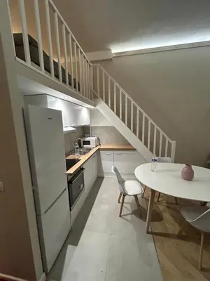 a small kitchen with a table and a white refrigerator at Sea Side, Modern, Nice Promenade in Nice