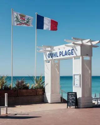 a kiosk with a sign in front of the beach at Sea Side, Modern, Nice Promenade in Nice